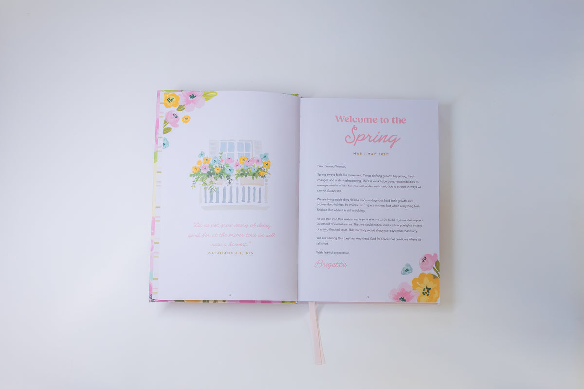 An open spring-themed journal or planner spread on a clean white background. The left page features a pastel watercolor illustration of flowers in a window box, and the right page has a 'Welcome to the Spring' heading with floral corner accents.