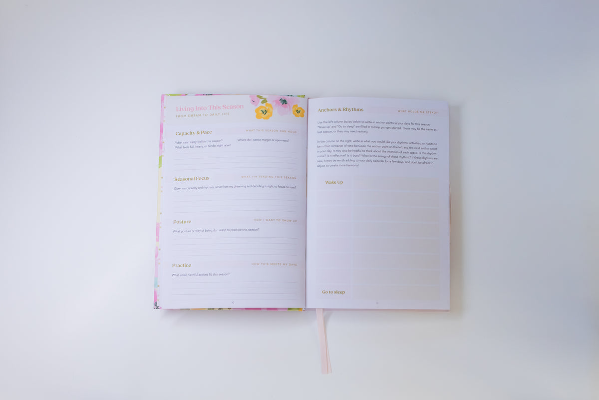 An open printed booklet or journal spread on a plain white background, showing two inner pages with text and faint floral border accents.