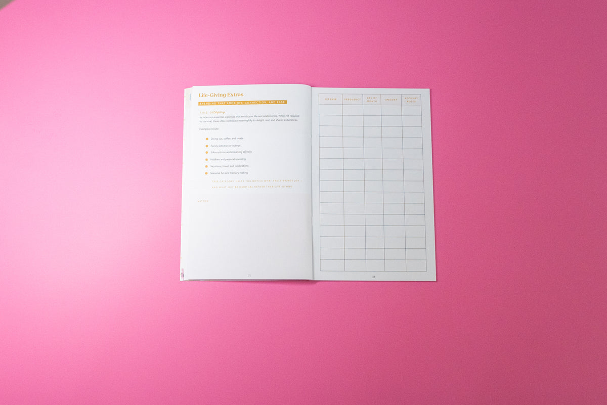 An open white planner insert or booklet showing a checklist and a grid table, placed on a solid bright pink background.